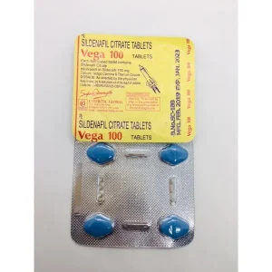 A blister pack of Sildenafil Citrate tablets with a yellow and red label that reads "Vega 100," containing six blue tablets and two silver capsules.